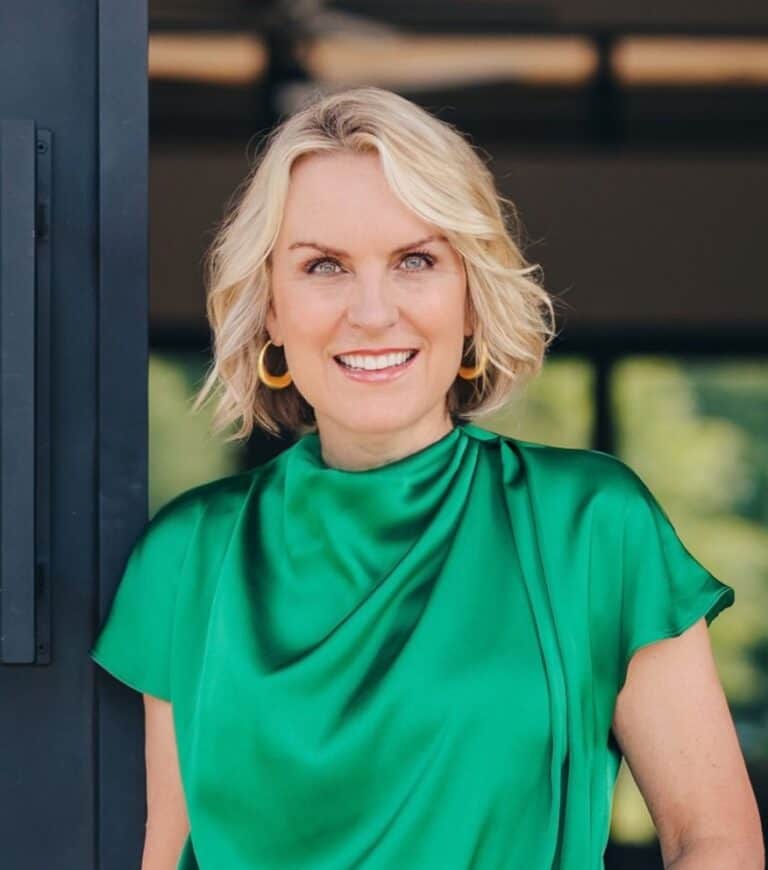 Portrait of Kim Mundorff smiling outdoors in Frisco, TX, wearing a vibrant green blouse, showcasing professional confidence and approachability.
